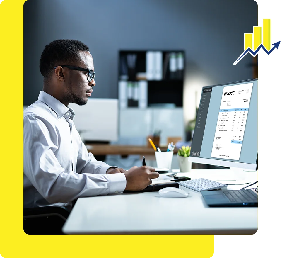 A man sitting at his desk working on a computer.