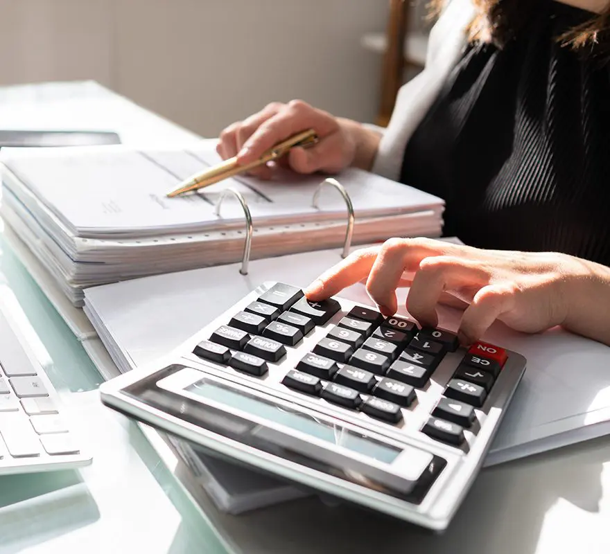 A person is using a calculator to calculate their taxes.