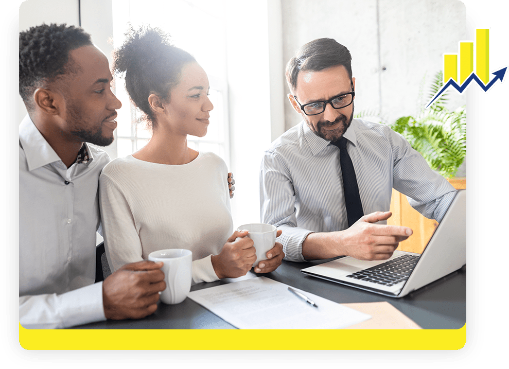 Three people sitting at a table with a laptop