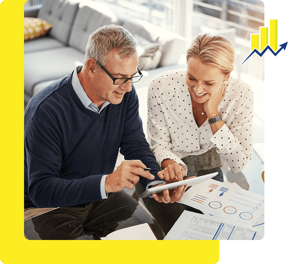 A man and woman looking at a tablet.